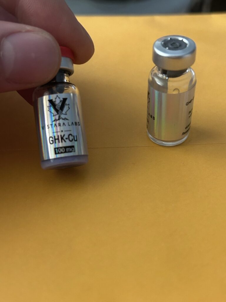 Customer photo of a Vistara Labs GHK-Cu 100 mg vial held beside a second vial